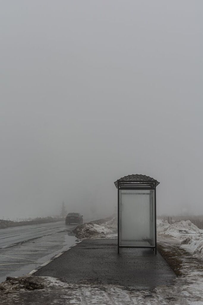 A misty winter scene of a bus stop in Viimsi, Estonia, with a foggy atmosphere.